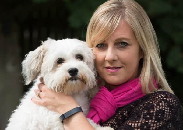 Kay Betson and her dog Woody who had his testicles injured after a cut at Pets at Home