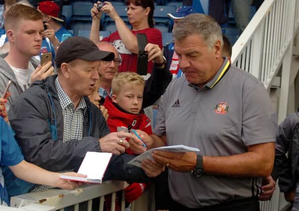 Sam Allardyce signs autographs for supporters during Sunderland's pre-season friendly at Hartlepool on Wednesday night. Picture: PA.