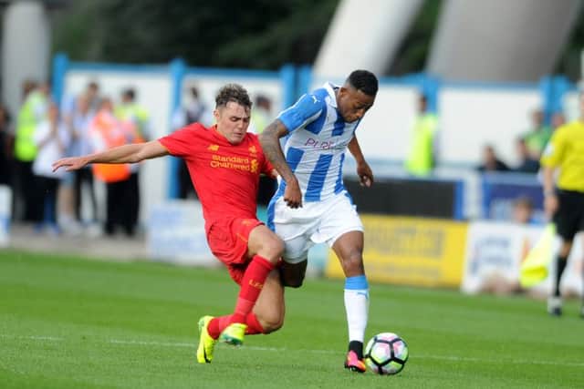 Huddersfield Town's Rajiv Van La Parra is tackled by Liverpool's Connor Randall. Picture: Tony Johnson.