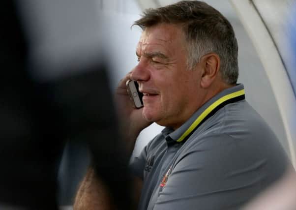 YES, SURE, I'LL TAKE THE JOB: Sunderland manager Sam Allardyce on the phone during the pre-season friendly match at Hartlepool on Wednesday night. Picture: Richard Sellers/PA.