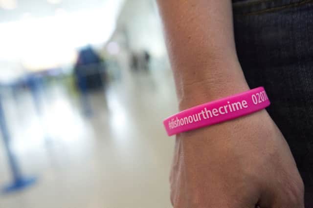 A wristband advertising a crackdown on female genital mutilation