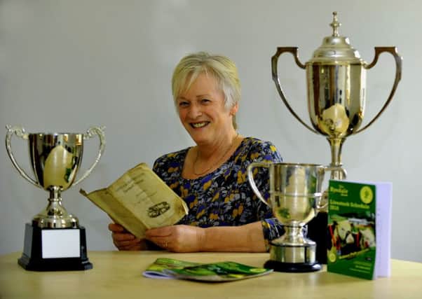 Christine Thompson, secretary of Ryedale Show, reading the original programme from the first ever Ryedale Show in 1856.  Pic: Gary Longbottom (Gl1010/54a)