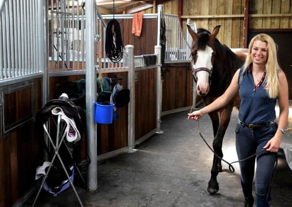BEST OF BRITAIN: Showjumper Laura Robinson from Potto, Northallerton, with Cassie, a two year old filly, in the stables. Picture by Gary Longbottom.