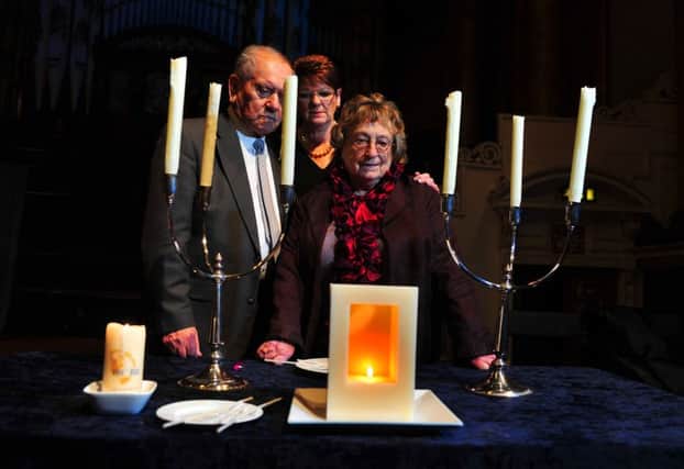 Holocaust survivors Arek Hersch and Iby Knill, with Lilian Black from the Holocaust Survivor's Friendship Association light a candle  in Leeds Town Hall. Picture Tony Johnson
