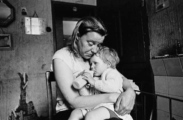 Exhibition of 1960s photographs show life  in inner-city slums.  Mrs Tandy and her youngest.