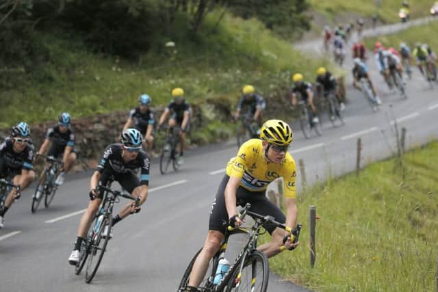 Britain's Chris Froome, wearing the overall leader's yellow jersey, leads the pack as they speed downhill during the nineteenth stage of the Tour de France on Friday, July 22, 2016. (AP Photo/Christophe Ena)