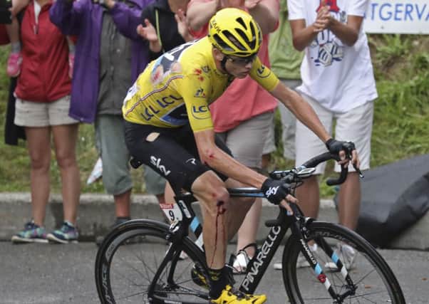 Britain's Chris Froome, wearing his torn overall leader's yellow jersey, bleeds after crashing during the nineteenth stage of the Tour de France cycling race over 146 kilometers (90.7 miles) with start in Albertville and finish in Saint-Gervais Mont Blanc, France. (Keno Tribouillard via AP Photo)