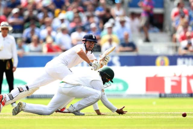 England's Alastair Cook nudges one past short leg at Old Trafford off the bowling of Yasir Shah. Picture: Martin Rickett/PA.