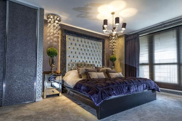 The opulent bedroom with a bespoke headboard and a bed that Ben made from an Ikea frame lit from beneath by plug-in, remote control LED lights
