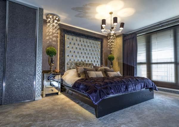 The opulent bedroom with a bespoke headboard and a bed that Ben made from an Ikea frame lit from beneath by plug-in, remote control LED lights