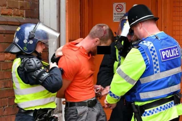 A man is arrested outside the ground