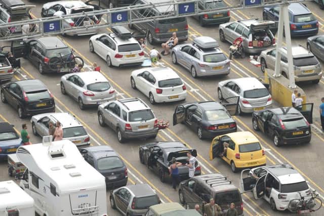 People sit next to their vehicles at the Port of Dover in Kent as motorists face more misery on the roads to Dover amid disruption expected to last until Monday. PRESS ASSOCIATION Photo. Picture date: Sunday July 24, 2016. Some people were forced to spend the night in their cars after getting stuck in jams leading to the port. See PA story TRANSPORT Channel. Photo credit should read: Yui Mok/PA Wire
