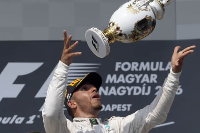 Lewis Hamilton of Britain celebrates after winning the Hungarian Formula One Grand Prix at the Hungaroring racetrack. Picture: AP/Darko Vojinovic