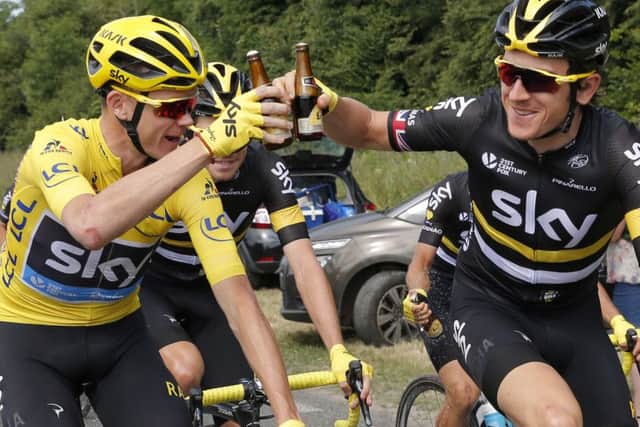 CHEERS! Britain's Chris Froome, wearing the overall leader's yellow jersey, and his Sky teammate Geraint Thomas toast with bottles of beer. Picture: AP/Christophe Ena