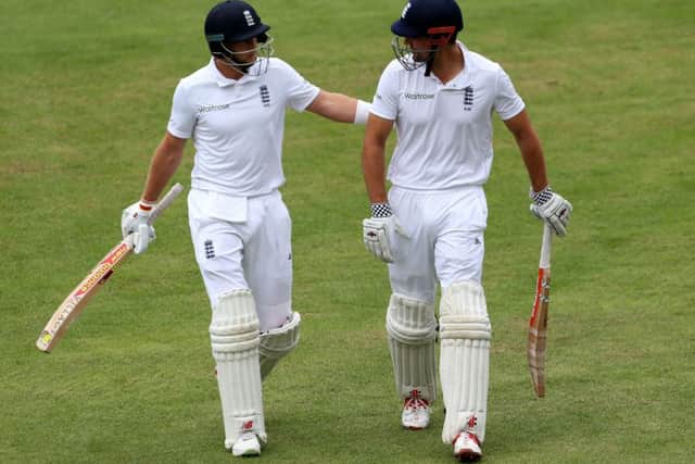England's Joe Root, left, and captain Alistair Cook walk off after declaring during day four of the Second Test