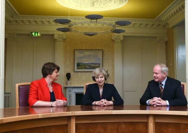 Prime Minister Theresa May with First Minister Arlene Foster and Deputy First Minister Martin McGuinness at Stormont Castle in Belfast