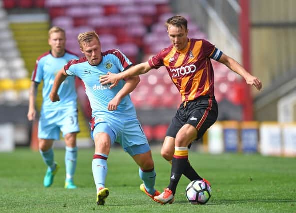 The abuse is said to have taken place during Bradford's match against Burnley on Saturday. Here Burnley's Rouwen Hennings is held back by Bradford City's Tony McMahon during the pre-season friendly. Photo: Dave Howarth/PA Wire.