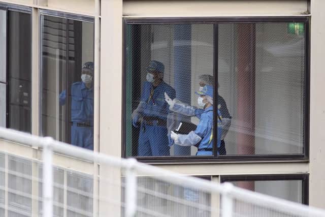 Police investigators work at the Tsukui Yamayuri-en, a facility for the disabled where a number of people were killed and dozens injured.(AP Photo/Eugene Hoshiko)
