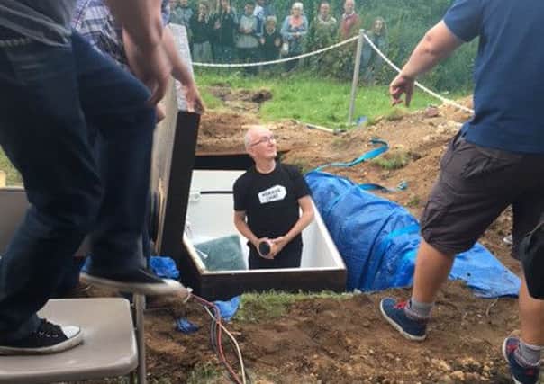 Charity worker John Edwards being exhumed after spending 72 hours broadcasting live from a coffin buried in Halifax.