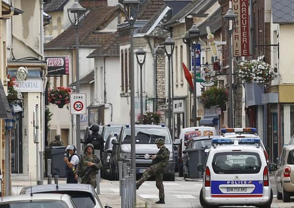 French soldiers stand guard near the scene of an attack in Saint-Etienne-du-Rouvray, Normandy, France, in which a priest, aged 84, was killed.