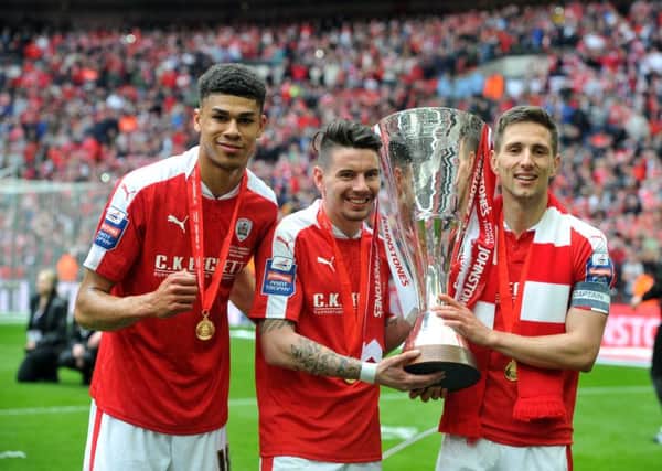 Barnsley's Ashley Fletcher, Adam Hammill and Conor Hourihane with the Johnstone's Paint Trophy after victory over Oxford at Wembley (Picture: Tony Johnson).