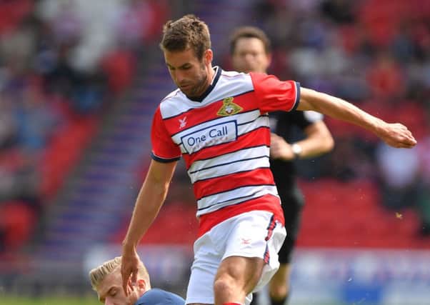 NEW FACE: Doncaster Rovers' Matty Blair, battling with Boros Adam Clayton during a pre-season friendly. Picture: PA