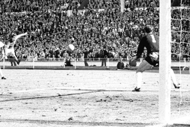 It's all over: Geoff Hurst cracks a shot past German goalkeeper Hans Tilkowski to seal victory for England. (PA)