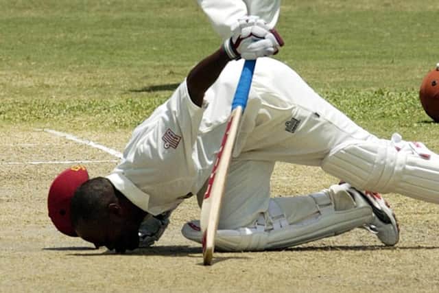West Indies' Brian Lara kisses the wicket after breaking the world record score of 380 during the third day of the fourth Test against England in Antigua in April 2004. Picture: Rebecca Naden/PA.