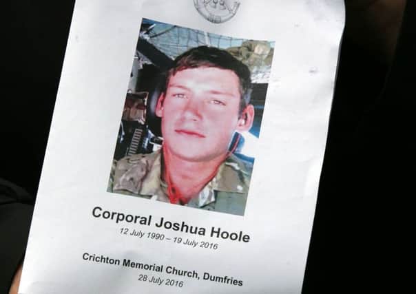 The Order of Service is held up after the funeral of Corporal Josh Hoole at Crichton Memorial church in Dumfries. PIC: PA