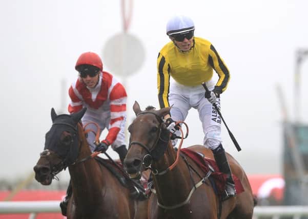 Big Orange ridden by jockey Jamie Spencer, right, coming home to win the Qatar Goodwood Cup (Picture: John Walton/PA Wire).