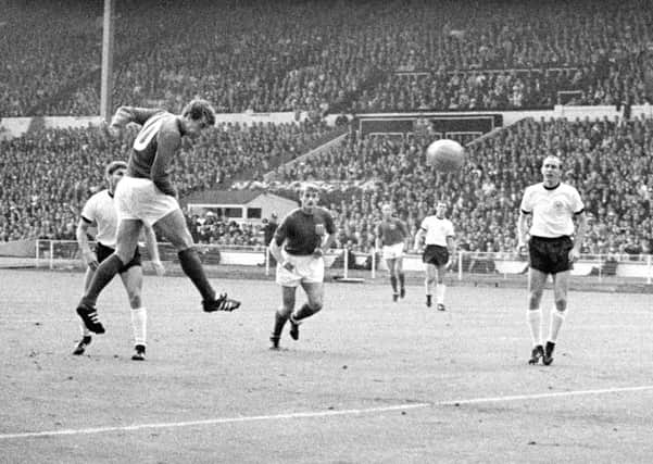 England's Geoff Hurst heads the equalising goal, watched by team-mate Roger Hunt (Picture: PA Wire).