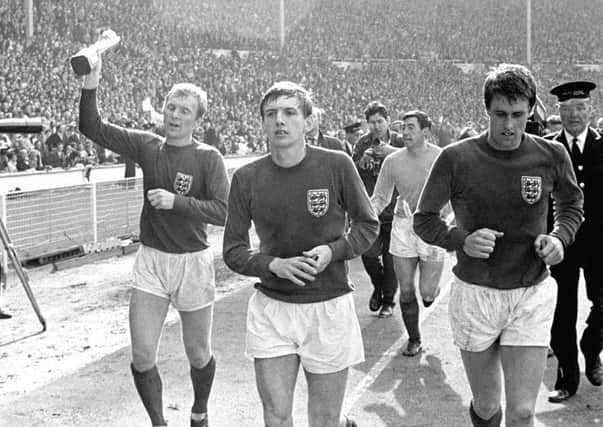 West Ham United players Bobby Moore, Martin Peters and Geoff Hurst during England's lap of honour at Wembley following the World Cup final in 1966 (Picture: PA Wire).