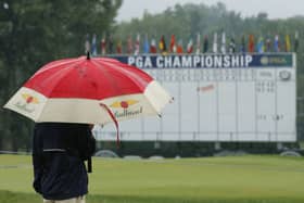 Washout: A man stands by the 18th hole after third round play was suspend for the day at the PGA Championship.
Picture: AP Photo/Tony Gutierrez