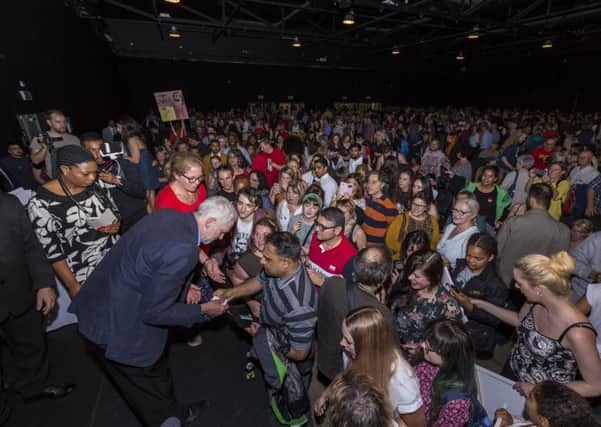 Labour leader Jeremy Corbyn (left, stooping) at a packed leadership campaign rally at New Dock Hall, Leeds.
Picture taken on Saturday 30 July 2016.