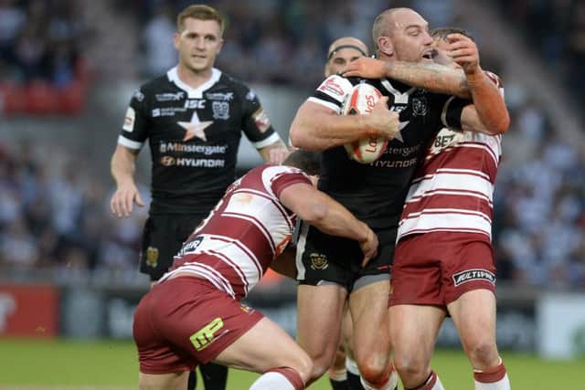 Hull's Gareth Ellis is held by Willie Isa and Sea O'Loughlin, of Wigan, during Friday's Challenge Cup semi-final (Picture: Bruce Rollinson).