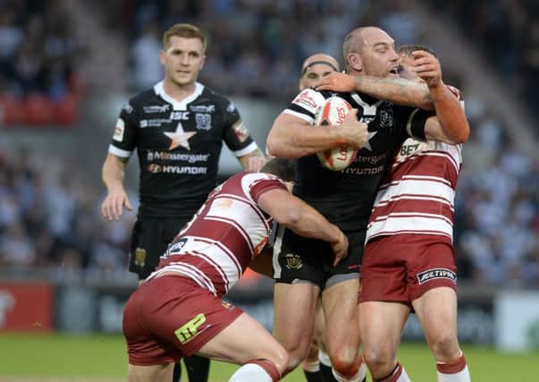 Hull's Gareth Ellis is held by Willie Isa and Sea O'Loughlin, of Wigan, during Friday's Challenge Cup semi-final (Picture: Bruce Rollinson).