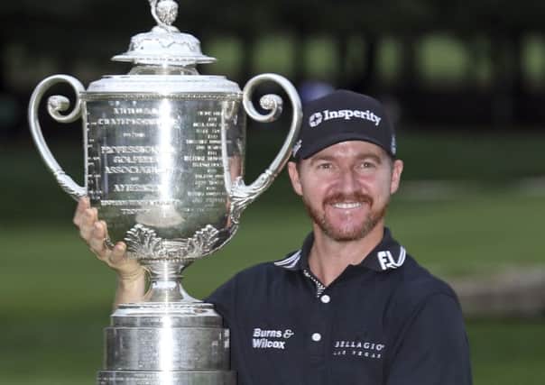 Jimmy Walker poses with the trophy after winning the PGA Championship