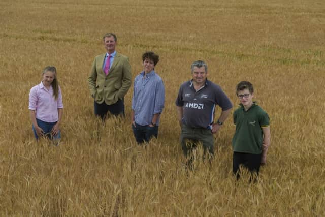 Simon Cockerill with his children Tabitha, 13, Angus, 16, and local farmer Mark Lockwood, next to his son Edward, 13.