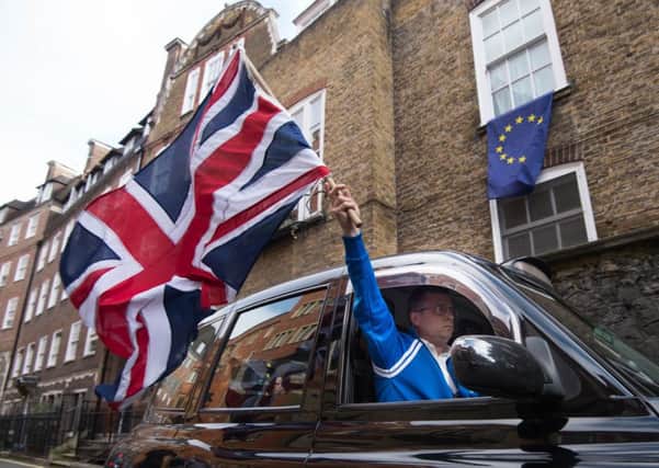 A taxi driver waves their flag in support of Brexit after the June 23 referendum.