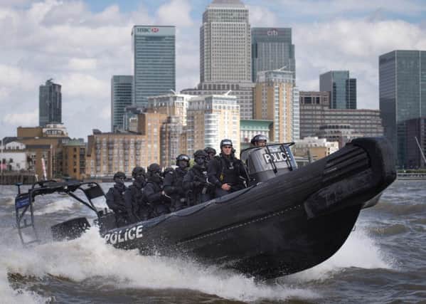 Armed police take part in a counter terrorism operation on the River Thames in London.