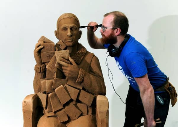 Sand artist Jamie Wardley models Bradford-born magician Dynamo, at The Broadway Shopping Centre.
Picture: Jonathan Gawthorpe