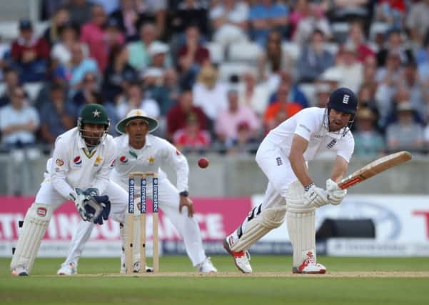 England batsman Alastair Cook pushes the ball watched by Pakistan wicketkeeper Sarfraz Ahmed off bowling from Pakistan's Yasir Shah.