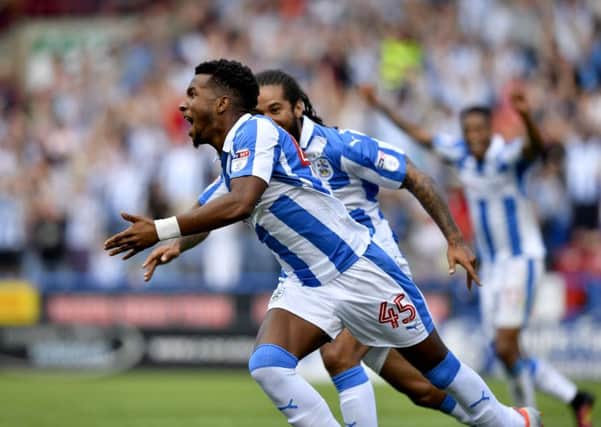 Huddersfield's Kasey Palmer, turns to celebrates after scoring the second and winning goal of the match.