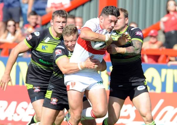 Chris Clarkson of Hull KR is held by Batley.