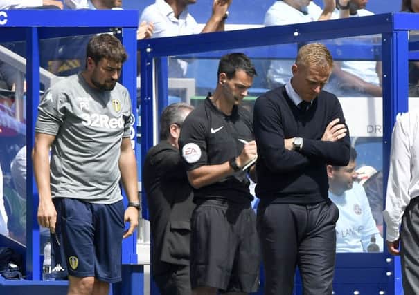 Dejected Leeds United head coach Garry Monk, right, and his assistant manager Pep Clotet, left, cannot bear to look as the Whites go down to an emphatic loss at QPR (Picture: James Hardisty).