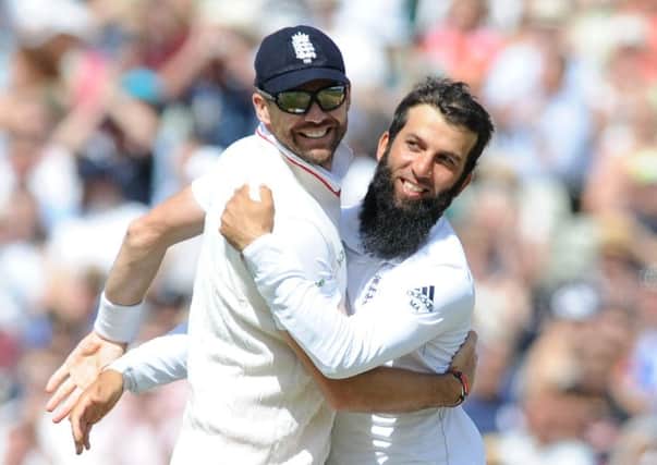 England's Moeen Ali (right) celebrates with James Anderson..