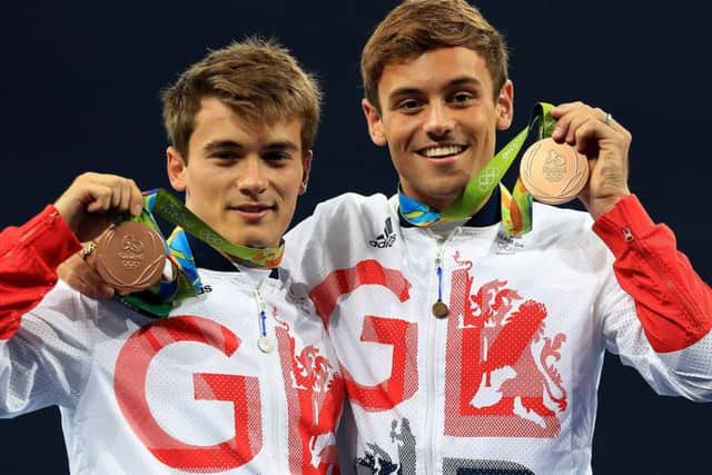 Great Britain's Tom Daley, right, and Daniel Goodfellow celebrate with their bronze medals after the men's synchronised 10m platform final