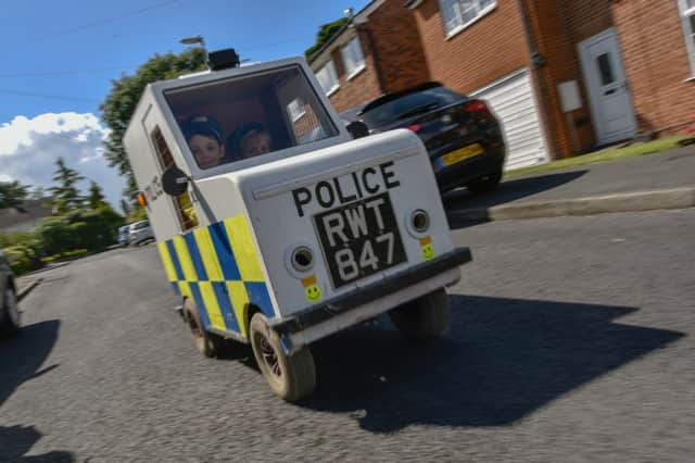 Frankie Robinson built a miniature police car with dad Allan. Picture: Ross Parry Agency