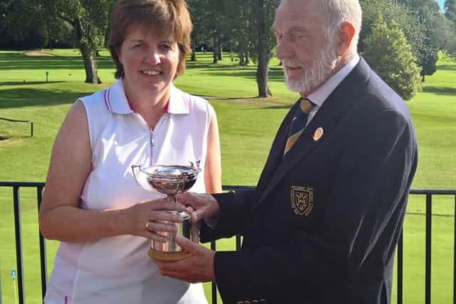 Gillian Petrie, winner of the individual gross trophy, with Harrogate Union president Robin Elias.