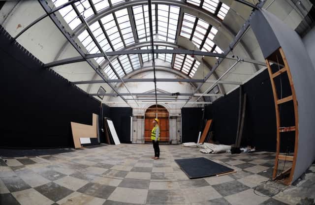 Audience development officer Lizzy Wilson views the uncovered ceiling at Leeds Art Gallery